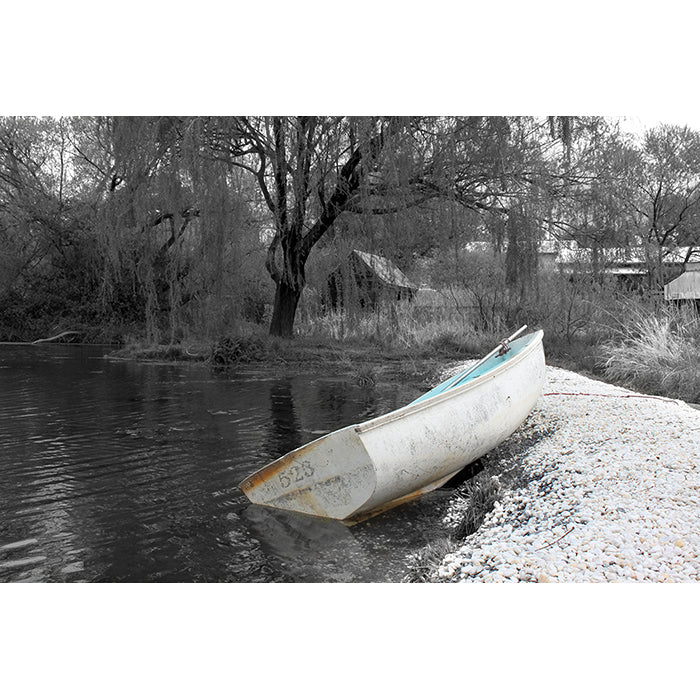 Image of a photographic art print featuring a row boat at the water's edge titled "Ashore" by Jessica St. Clair