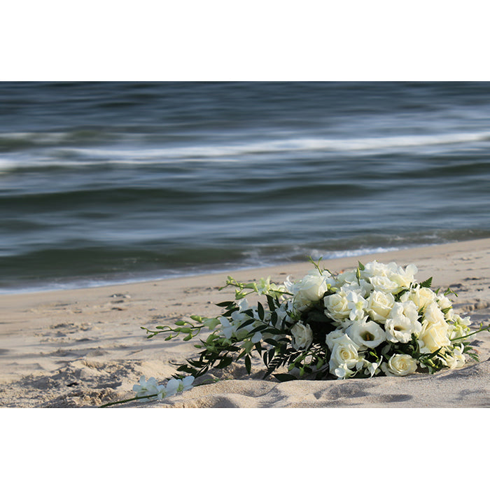 Image of Beach Bouquet photography artwork by Jessica St. Clair featuring a bridal flower bouquet on the sand at the water's edge