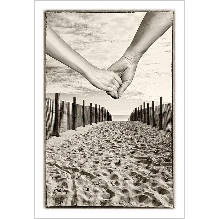 Image of The Journey mixed media sepia tone artwork by Jessica St. Clair depicting a couple holding hands as they walk down a sandy path that leads to the ocean