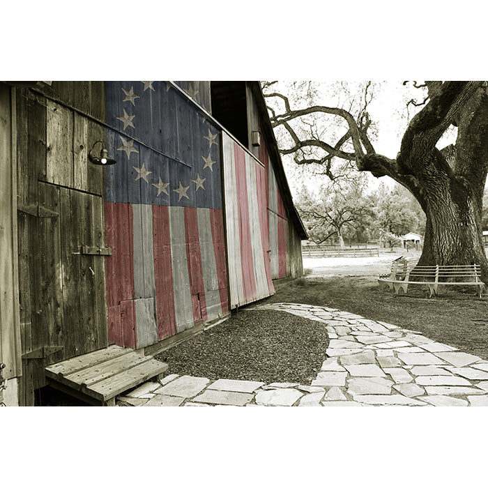 Image of Rustic Barn artwork illustrating an American flag painted on the wooden slats of an old barn by Jessica St. Clair