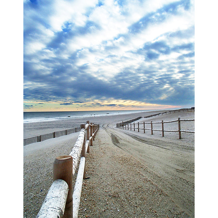 Image of Tomorrow's Promise photographic artwork by Jessica St. Clair depicting a sandy fence-lined path to the sea with a colorful sky at dusk