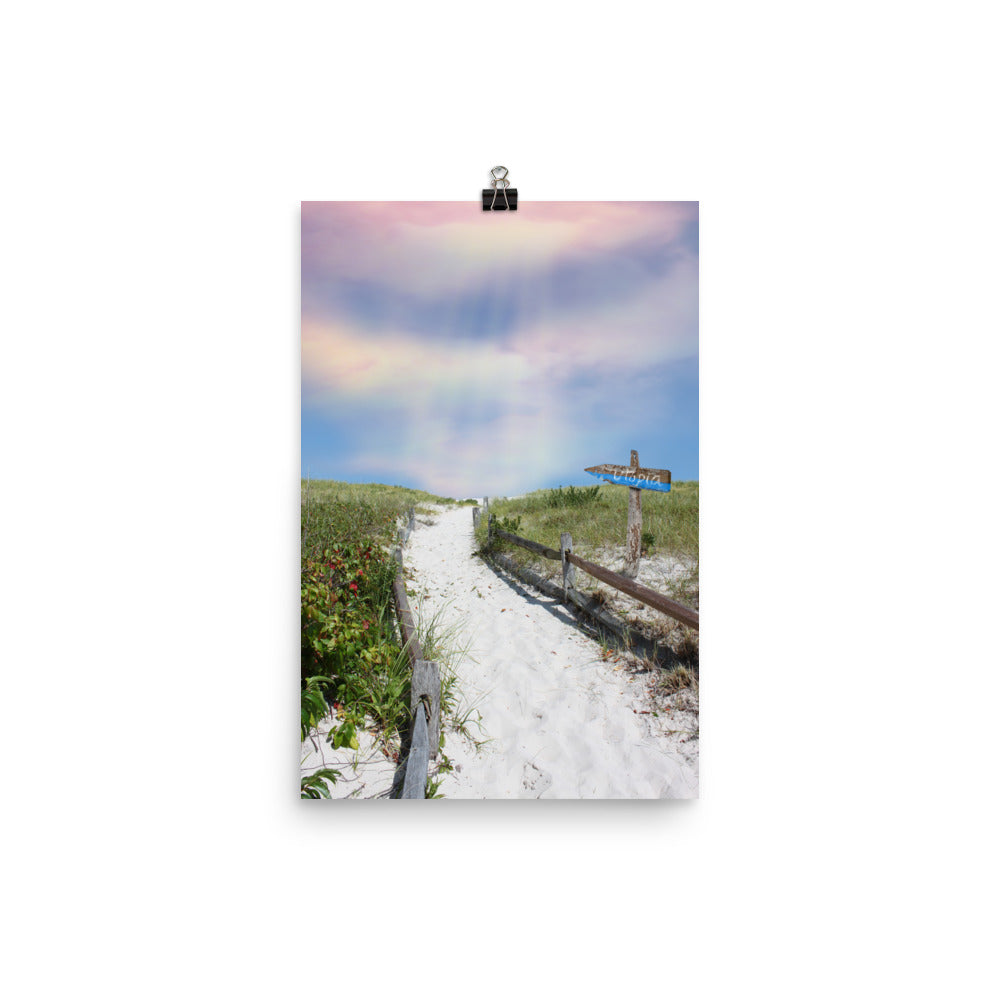 Image of This Way to Utopia mixed media 12 inch by 18 inch art print on enhanced matte photo paper by Jessica St. Clair featuring sun rays beaming down from a pastel sky and a sandy beach path with a wooden sign pointing the way toward Utopia