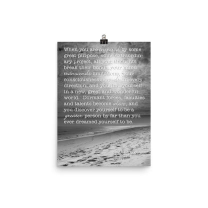 Image of 12 inch by 16 inch premium luster photo paper art print by Jessica St. Clair featuring black and white photography of footprints on the beach leading into the water with a Patanjali Yoga quote about the limitations one can transcend when inspired by great purpose overlaying the image