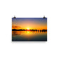 Image of Morning Majesty photographic art print on 12 inch by 18 inch premium luster photo paper by Jessica St. Clair depicting a colorful sunrise over a silhouetted dock stretching across the water