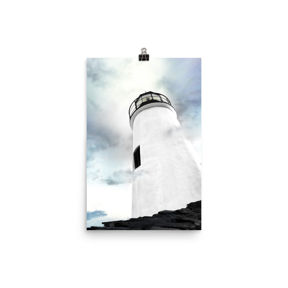 Image of The Sentinel photographic artwork by Jessica St. Clair on 12 inch by 18 inch premium luster photo paper looking upward from the rocky jetty to the top of a black and white lighthouse reaching toward an ethereal sky with artistic clouds