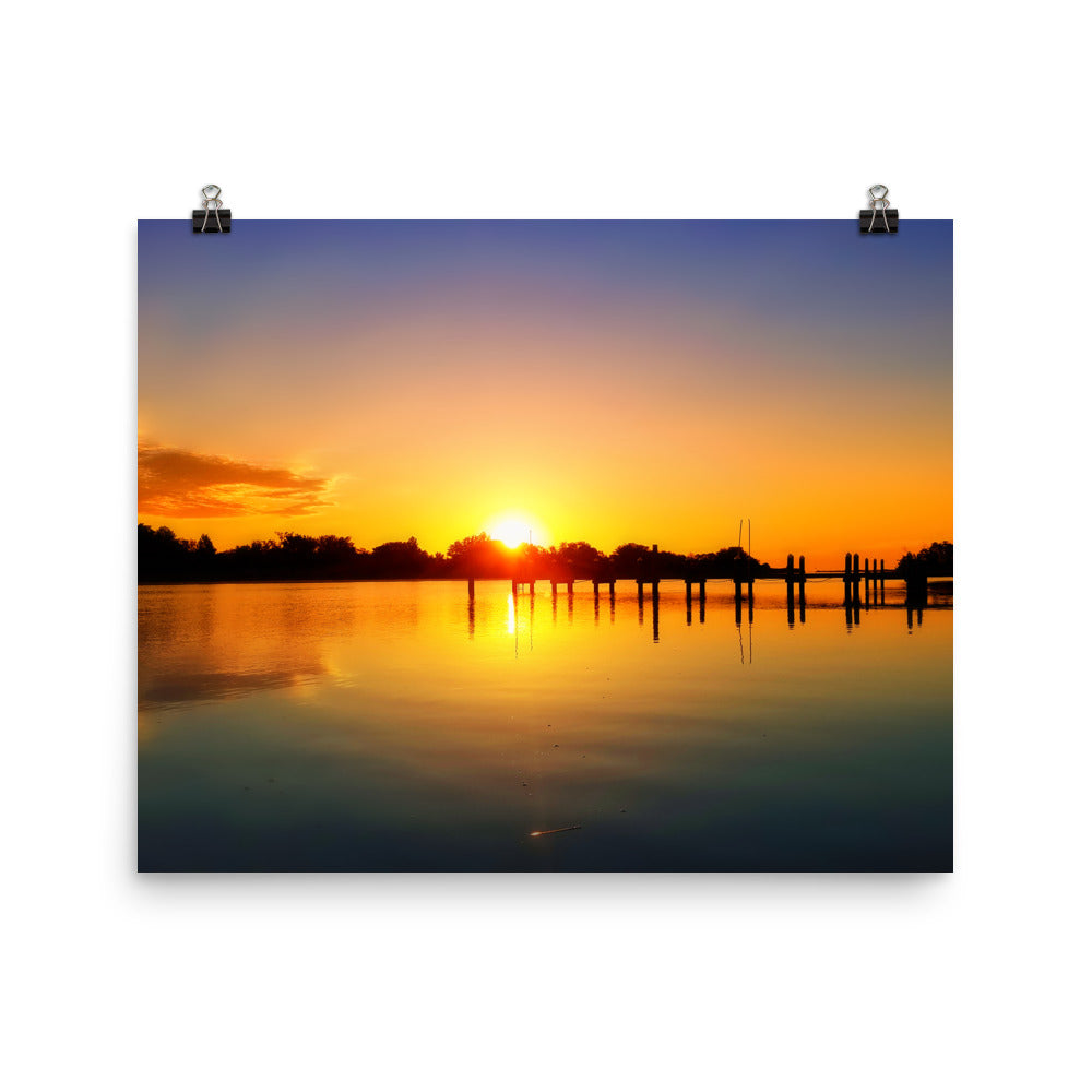 Image of Morning Majesty photographic art print on 16 inch by 20 inch premium luster photo paper by Jessica St. Clair depicting a colorful sunrise over a silhouetted dock stretching across the water