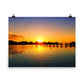 Image of Morning Majesty photographic art print on 18 inch by 24 inch premium luster photo paper by Jessica St. Clair depicting a colorful sunrise over a silhouetted dock stretching across the water