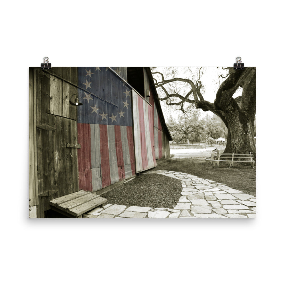 Image of Rustic Barn 24 inch by 36 inch art print illustrating an American flag painted on the wooden slats of an old barn