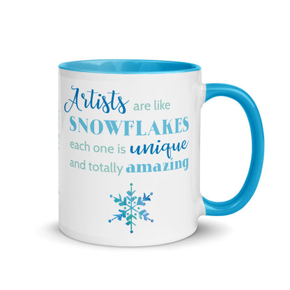 Image of front view of white ceramic mug featuring blue inside and handle with saying Artists are like snowflakes each one is unique and totally amazing