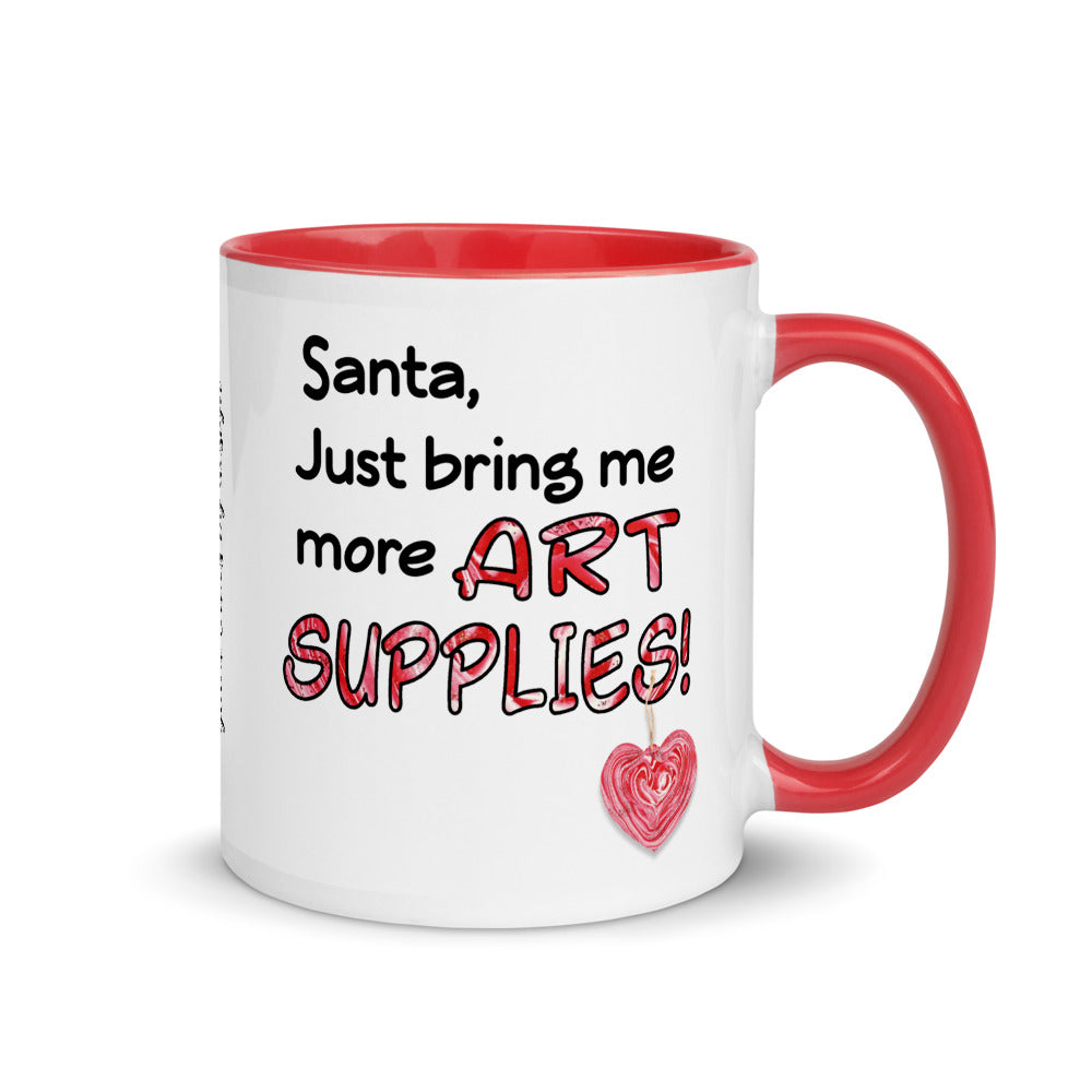 Image of front view of white ceramic mug featuring red inside and handle with Santa just bring me more art supplies saying